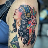 a tattoo of a woman with a flower headdress