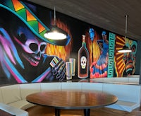 a colorful mural painted on the wall of a restaurant