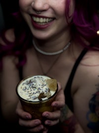 a woman holding a cup of coffee