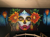 a mural of a woman with flowers on her face