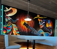 a colorful mural painted on the wall of a restaurant
