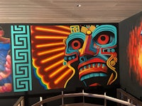 a mural of a mexican mask on a wall